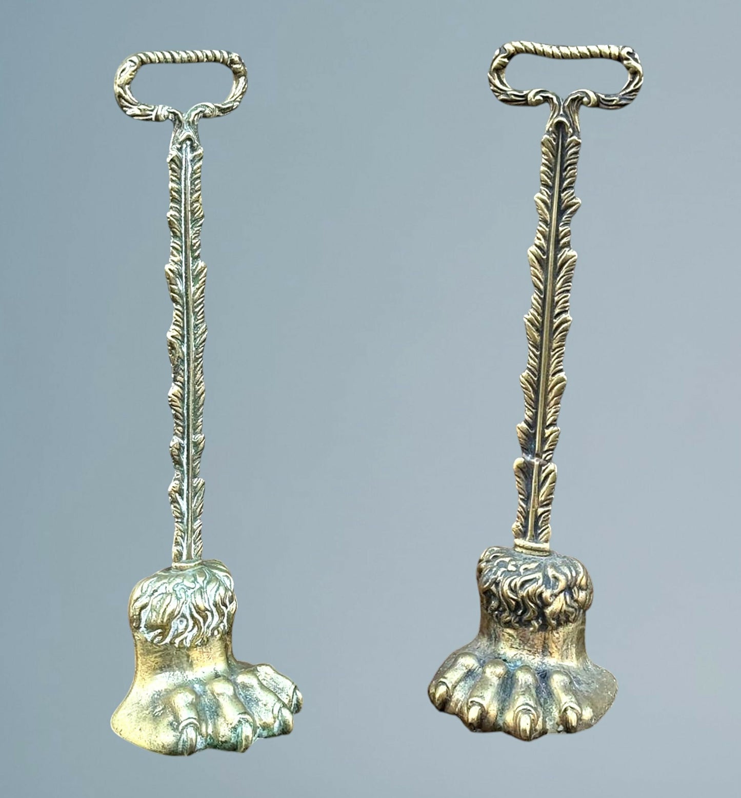 A Near Pair of 19th Century Brass Lion Paw Door Porters