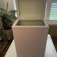 Mauve laundry basket with sage green interior.