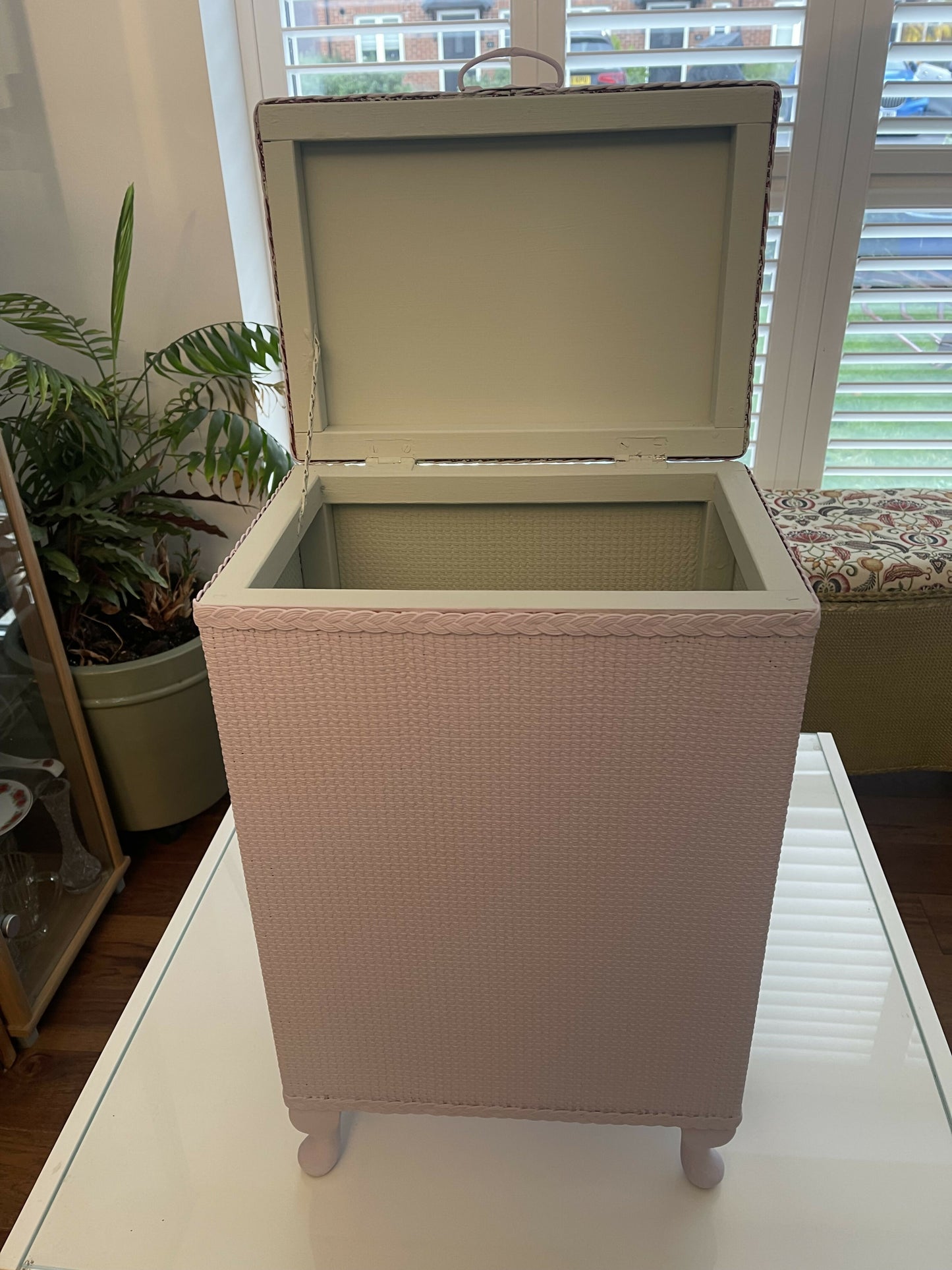 Mauve laundry basket with sage green interior.