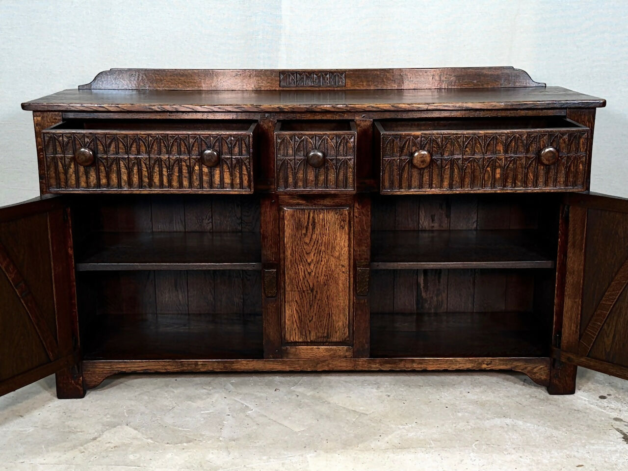 A NIGEL RUPERT GRIFFITHS MONASTIC CARVED OAK DRESSER BASE / SIDEBOARD / CABINET / CUPBOARD.