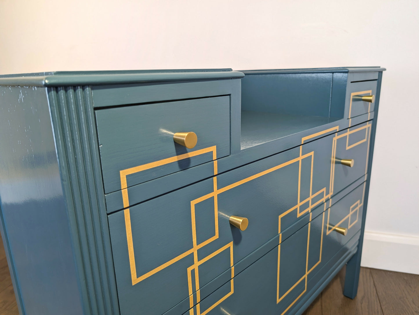 Blue and gold chest of drawers with geometric pattern and original mirrors