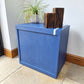 Small Simple Blue Chest Of Drawers With A White Stripe