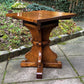 A RUPERT GRIFFITHS MONASTIC CARVED SOLID OAK LAMP TABLE / PLANT STAND