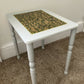 Light grey side table with hand-carved sage motif