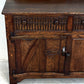 A NIGEL RUPERT GRIFFITHS MONASTIC CARVED OAK DRESSER BASE / SIDEBOARD / CABINET / CUPBOARD.