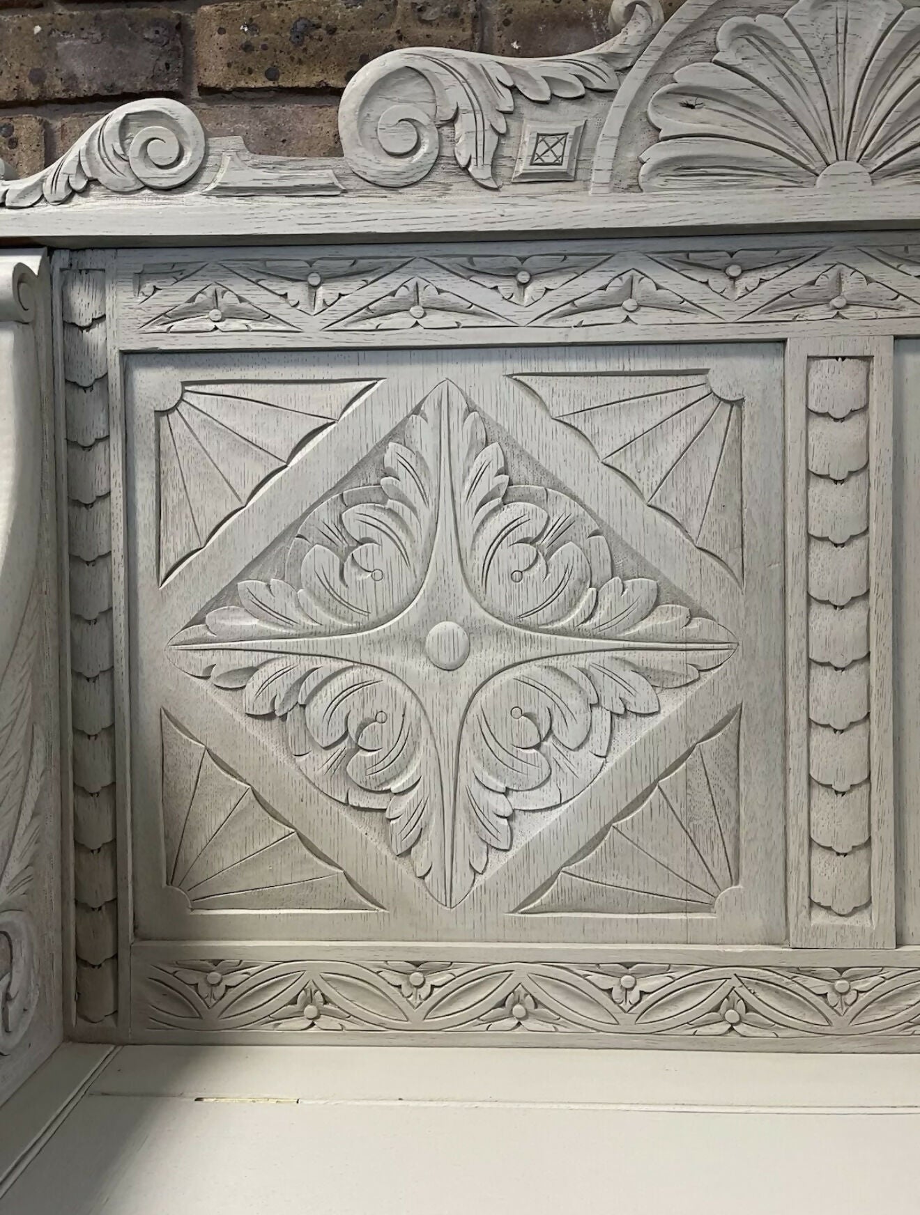 Edwardian antique Settle in solid oak with ornate carvings.