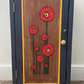 Dark grey wooden storage cabinet with hand carved flowers and linen interior