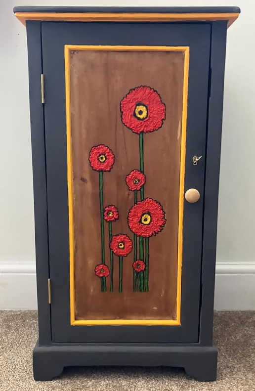 Dark grey wooden storage cabinet with hand carved flowers and linen interior