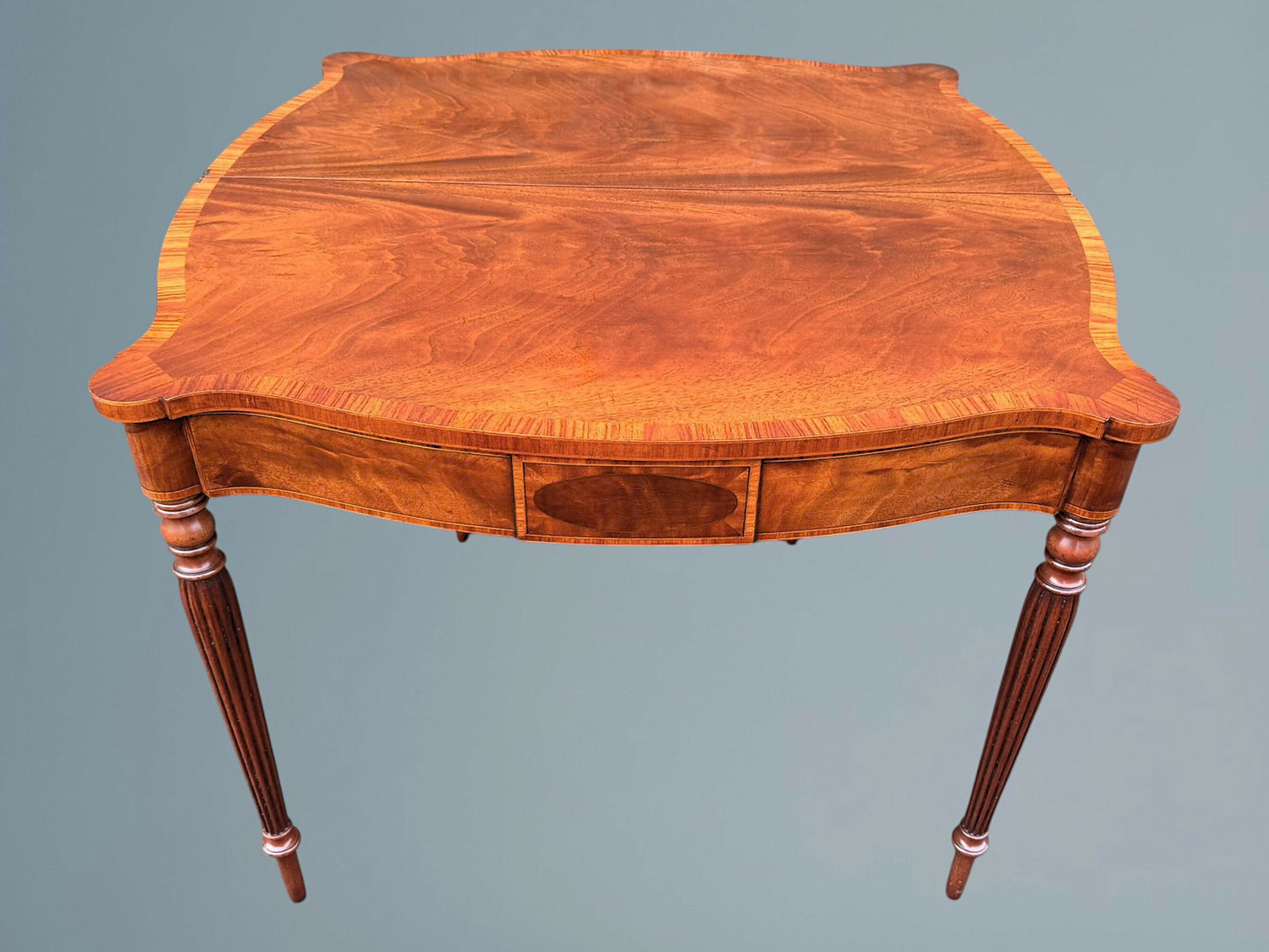 A Mahogany Serpentine Fronted Turn Over Top Tea Table