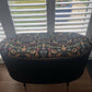 Black oval mid century modern ottoman - black paint William Morris style fabric