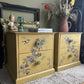 Pair of Upcycled Distressed Yellow Tables with Hidden Green-Blue Undertones & Elegant Floral Bird Design
