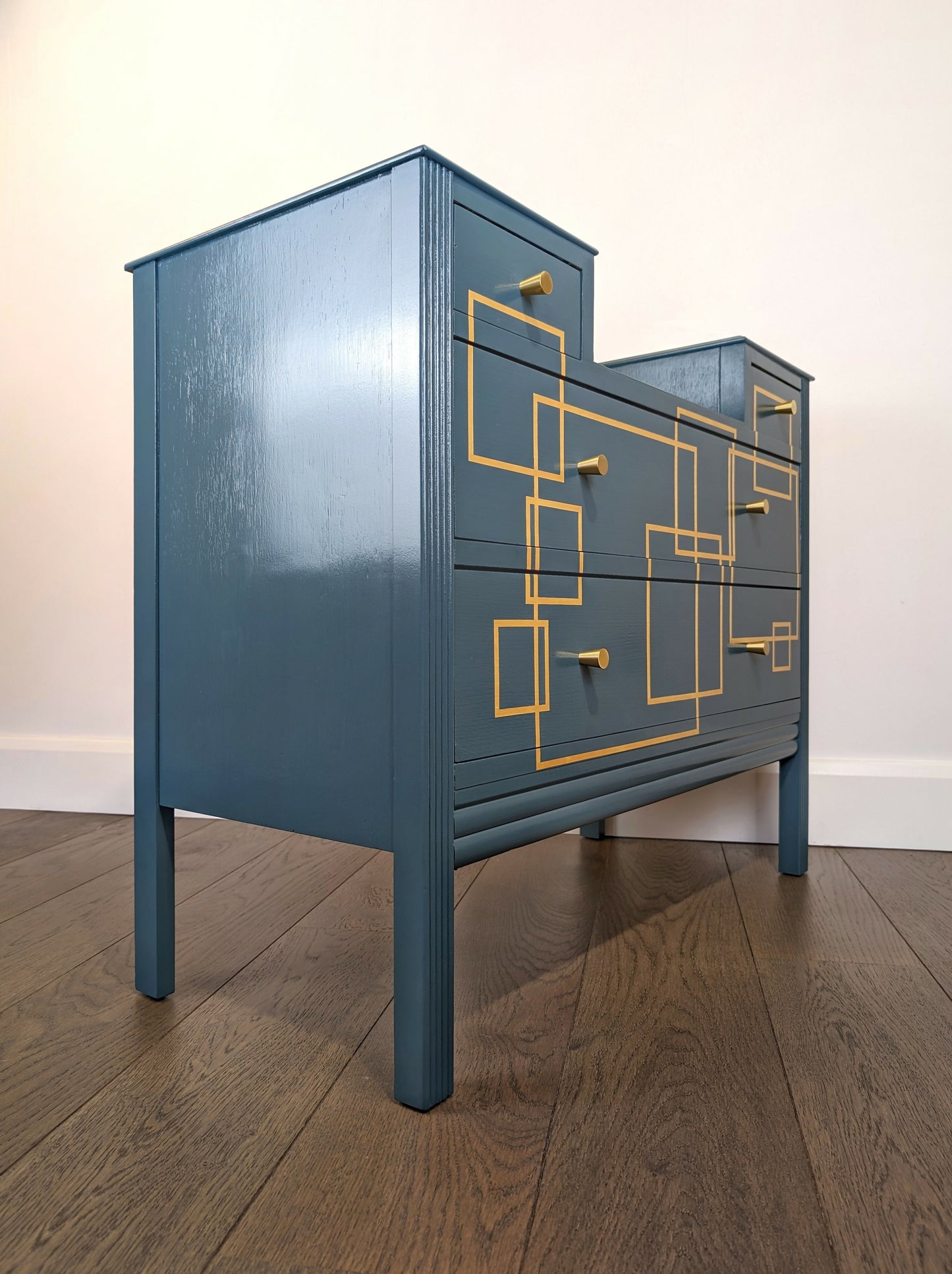 Blue and gold chest of drawers with geometric pattern and original mirrors