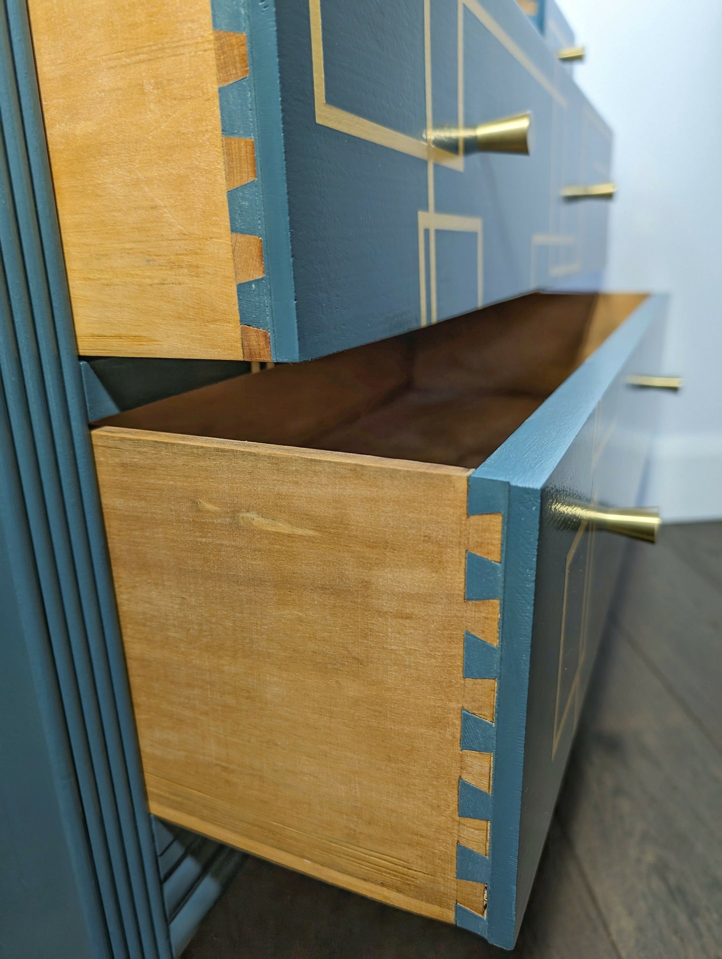 Blue and gold chest of drawers with geometric pattern and original mirrors