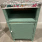 Green painted glass topped cabinet. Beautiful fabric accent top.