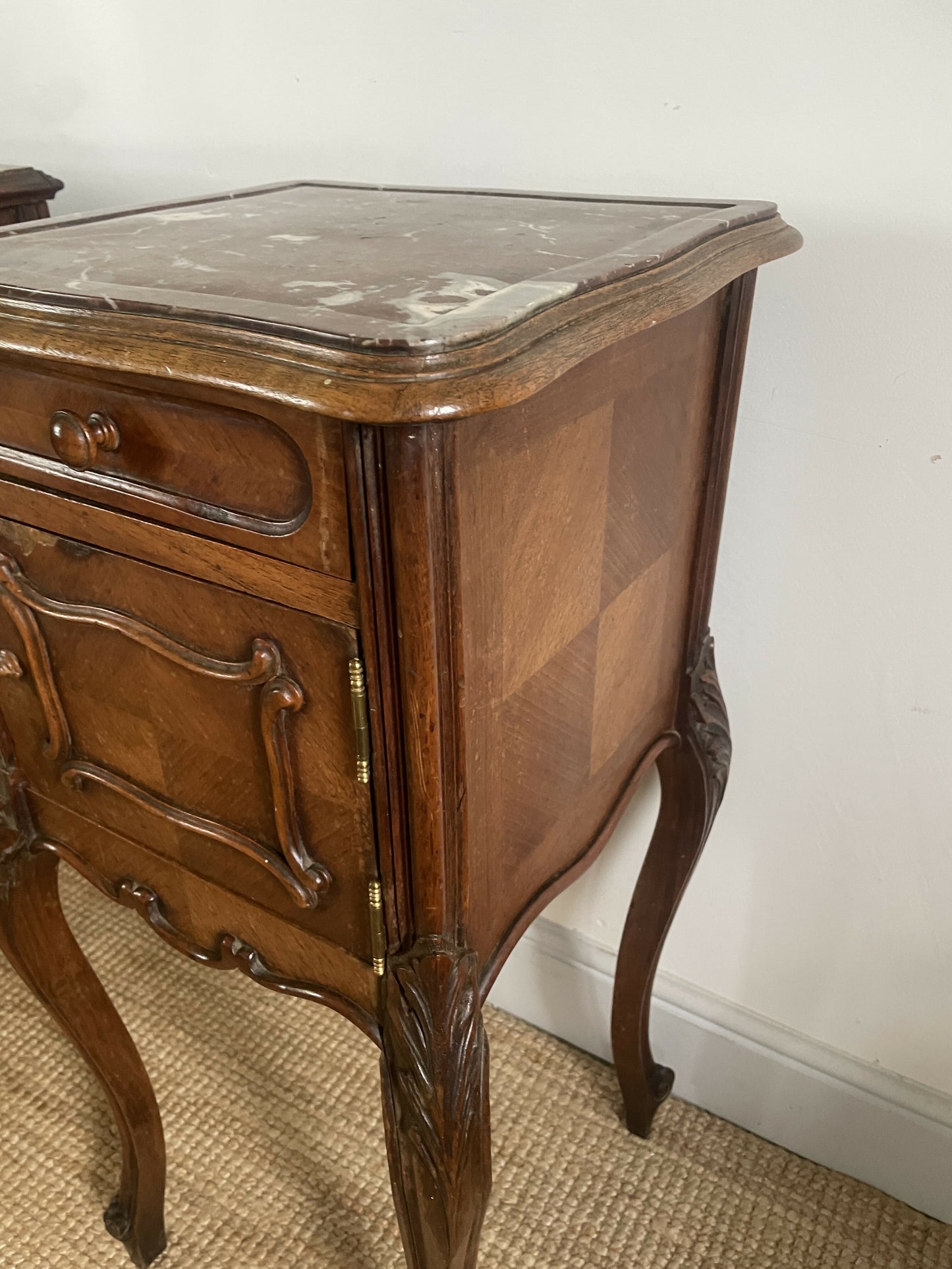 A near pair of antique French walnut and marble bedside tables