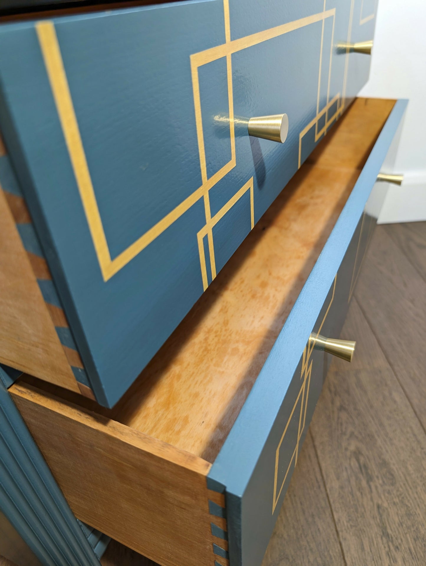 Blue and gold chest of drawers with geometric pattern and original mirrors