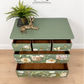 Sage green Stag Minstrel chest of drawers with neutral floral design. 3 over 2. Sideboard, dresser, bedside table