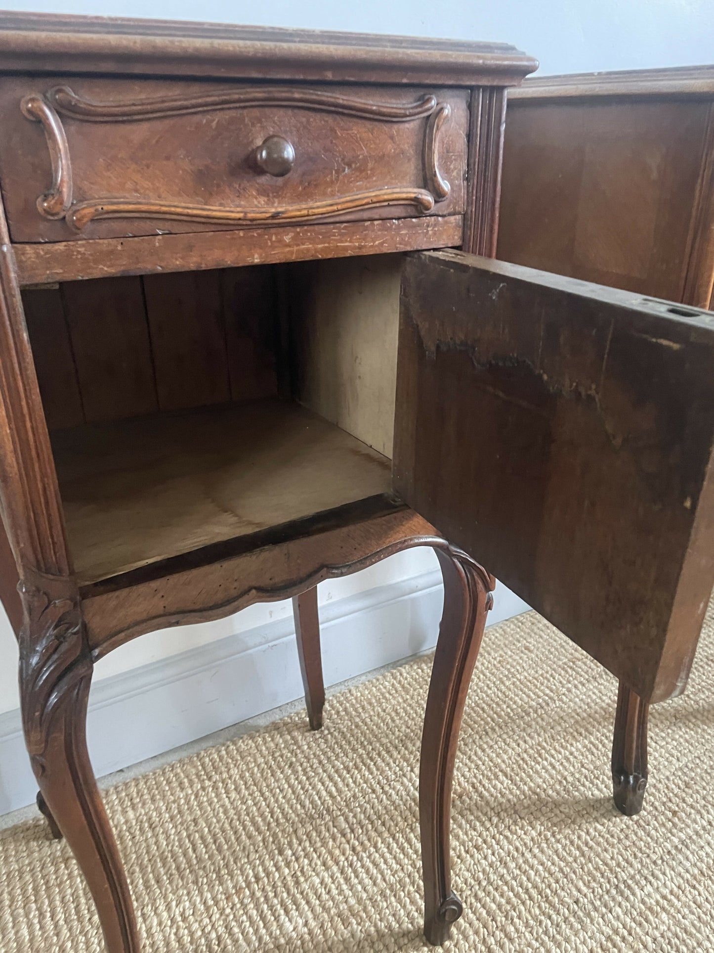 A near pair of antique French walnut and marble bedside tables