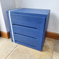 Small Simple Blue Chest Of Drawers With A White Stripe