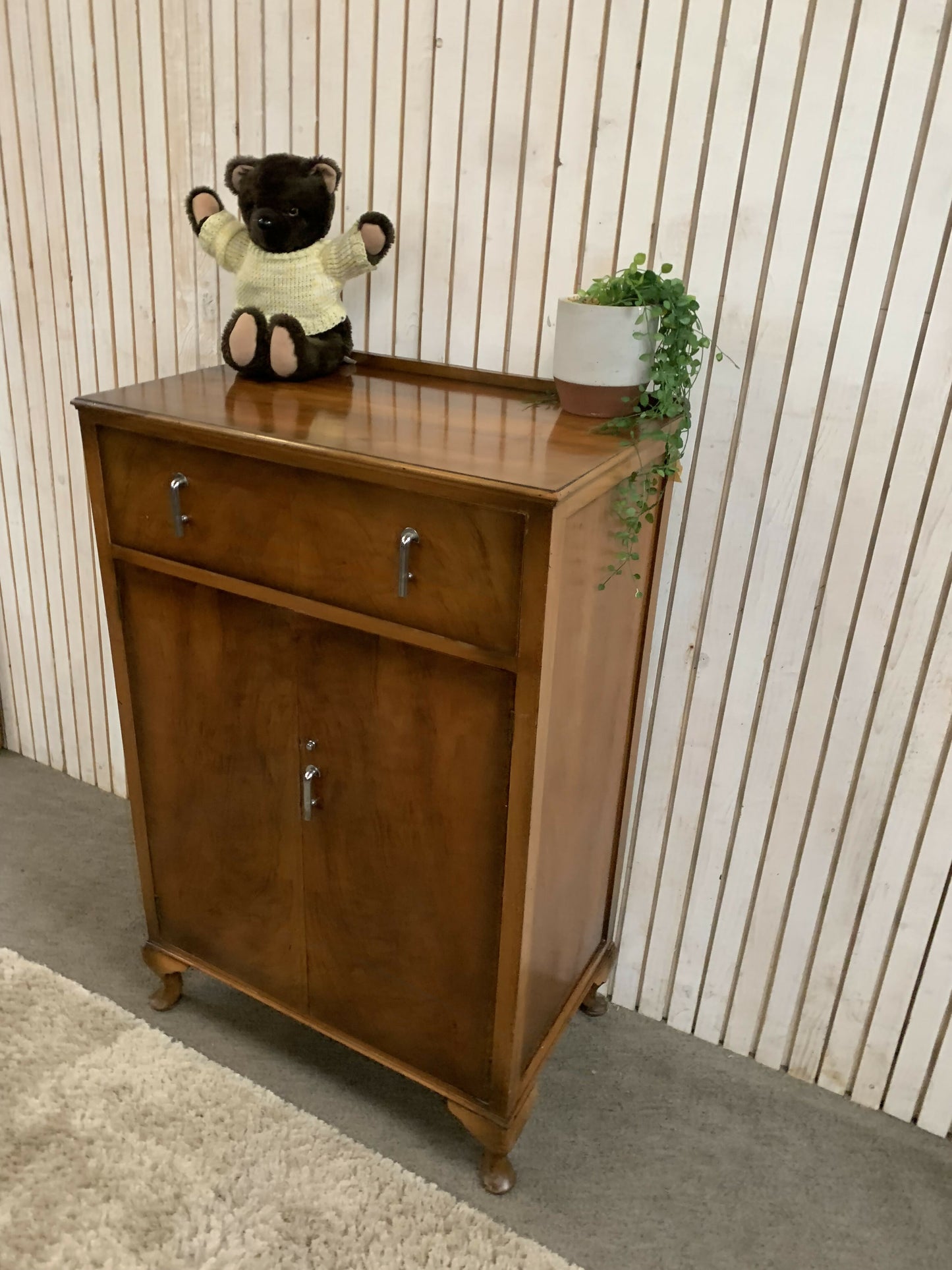 Vintage Art Deco burr walnut veneer cupboard featuring two doors and one drawer.