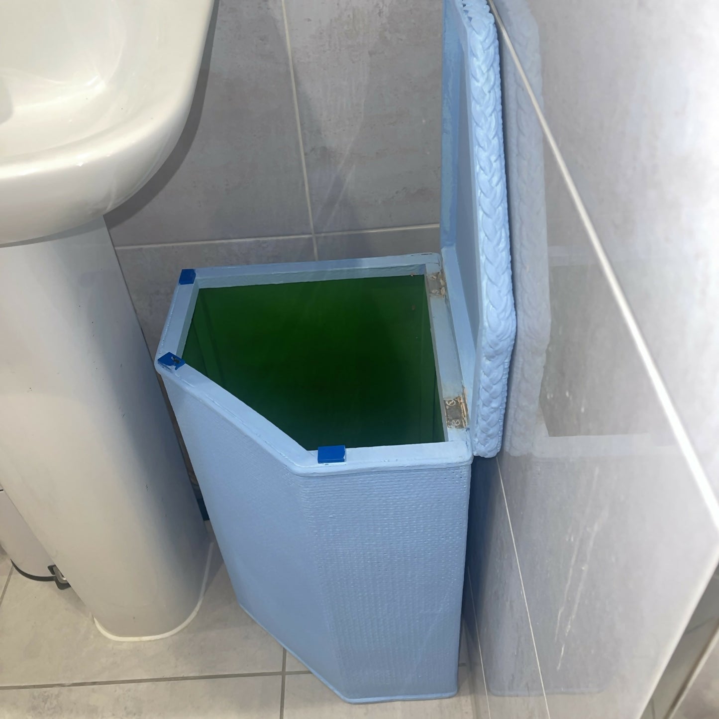 Laundry basket sky blue. Fits neatly under washhandbasin