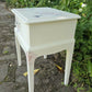 Stag Minstrel 'leggy' beside table with drawer painted in clotted cream