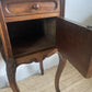 A near pair of antique French walnut and marble bedside tables