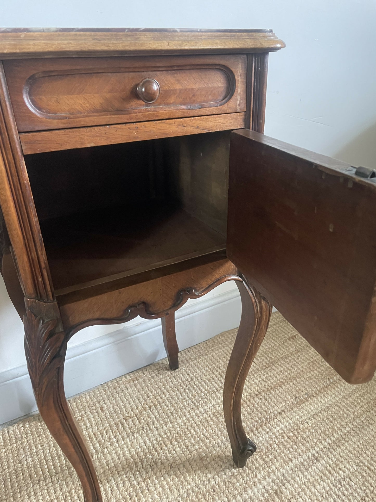 A near pair of antique French walnut and marble bedside tables