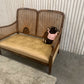 Very attractive and unique antique gold-colored cane bergère two-seater sofa.