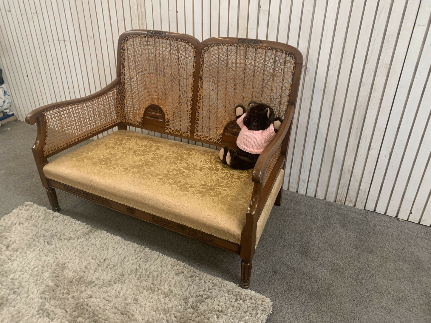 Very attractive and unique antique gold-colored cane bergère two-seater sofa.