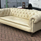Vintage Victorian Buttoned Back Chesterfield Sofa In Leather On Brass Castors.