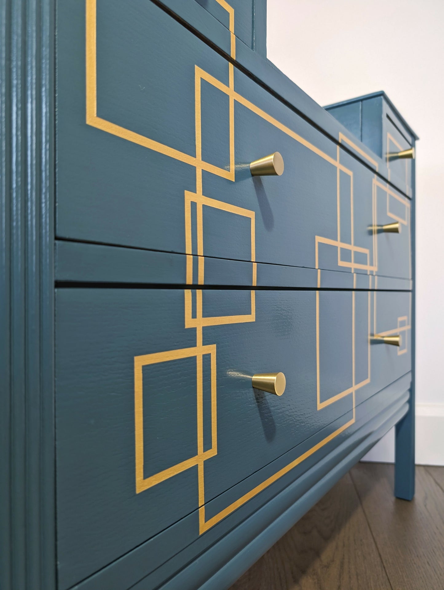 Blue and gold chest of drawers with geometric pattern and original mirrors