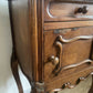 A near pair of antique French walnut and marble bedside tables