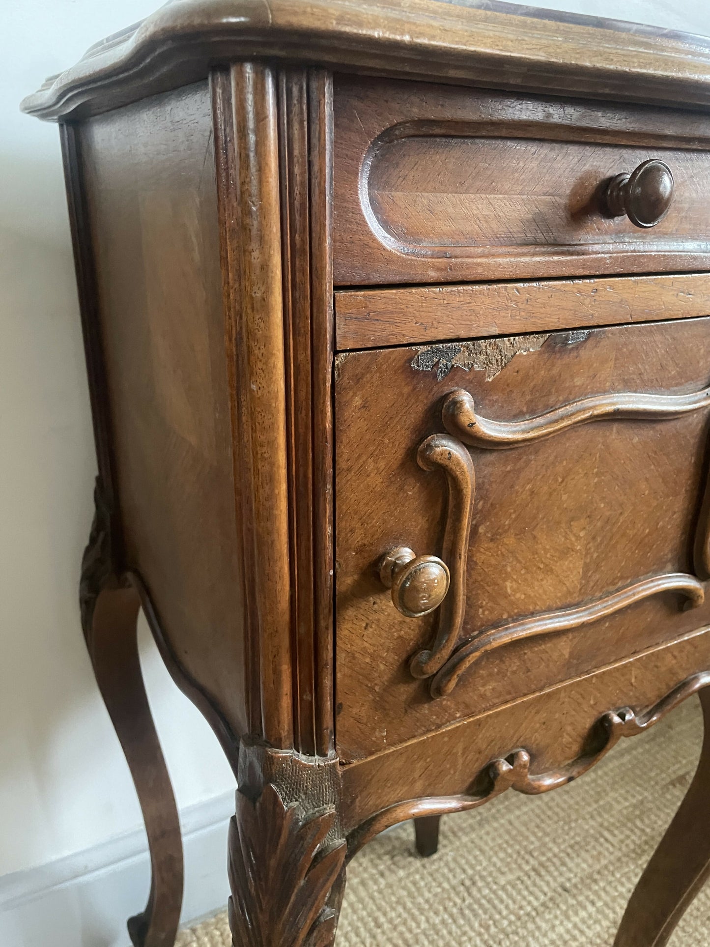 A near pair of antique French walnut and marble bedside tables