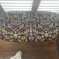 Black oval mid century modern ottoman - black paint William Morris style fabric
