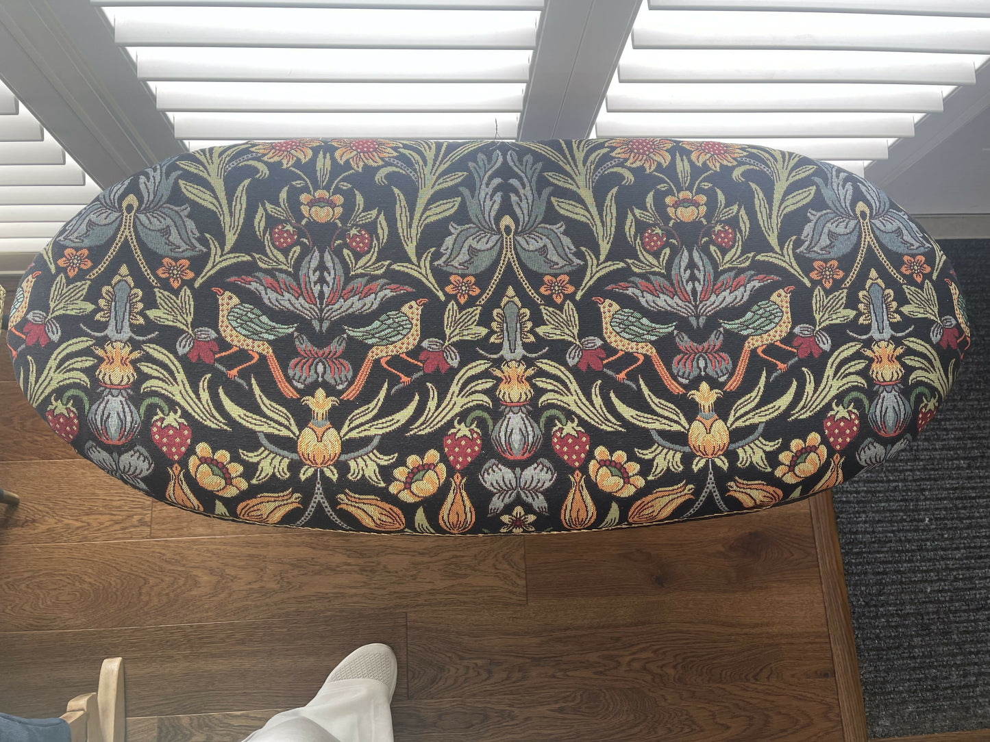 Black oval mid century modern ottoman - black paint William Morris style fabric
