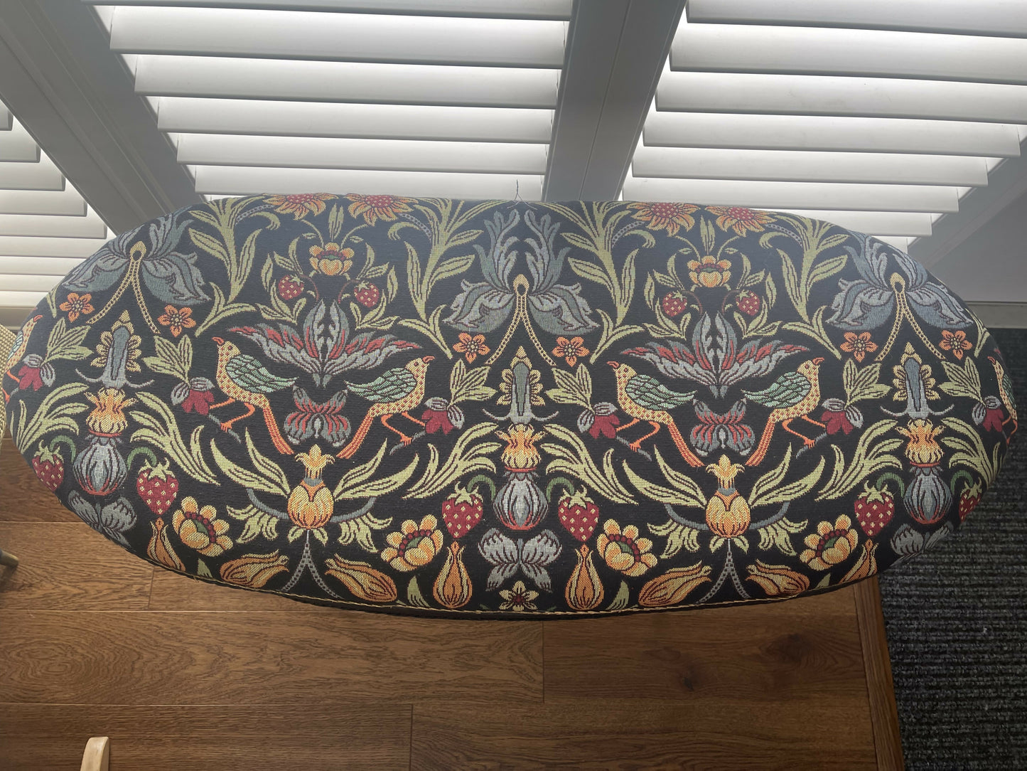 Black oval mid century modern ottoman - black paint William Morris style fabric