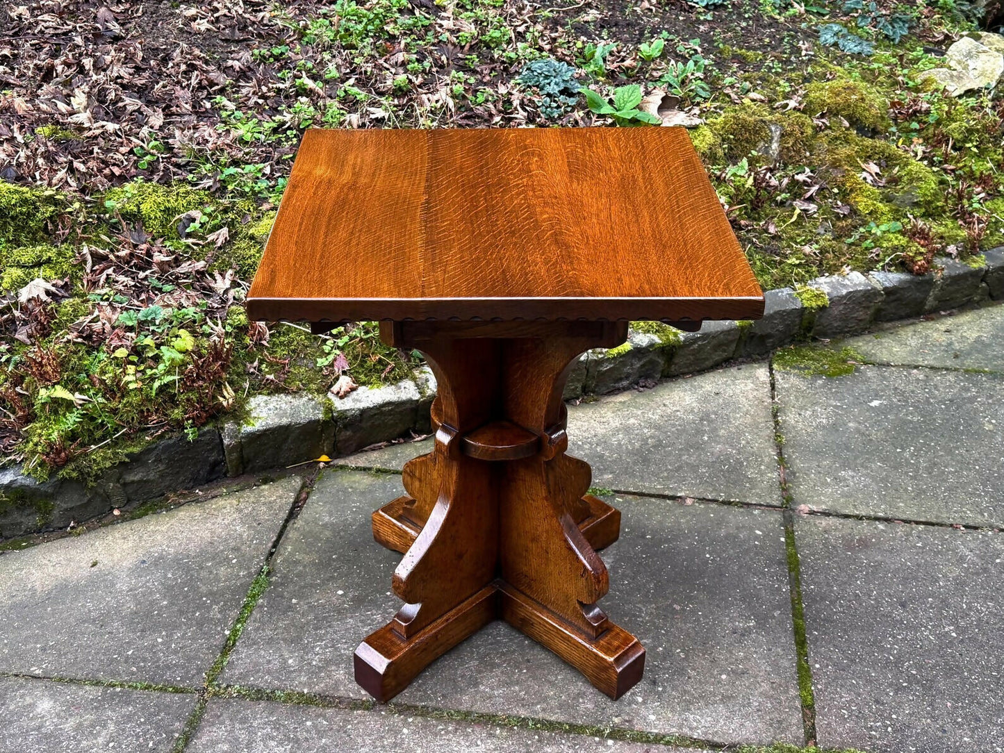 A RUPERT GRIFFITHS MONASTIC CARVED SOLID OAK LAMP TABLE / PLANT STAND