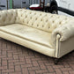 Vintage Victorian Buttoned Back Chesterfield Sofa In Leather On Brass Castors.