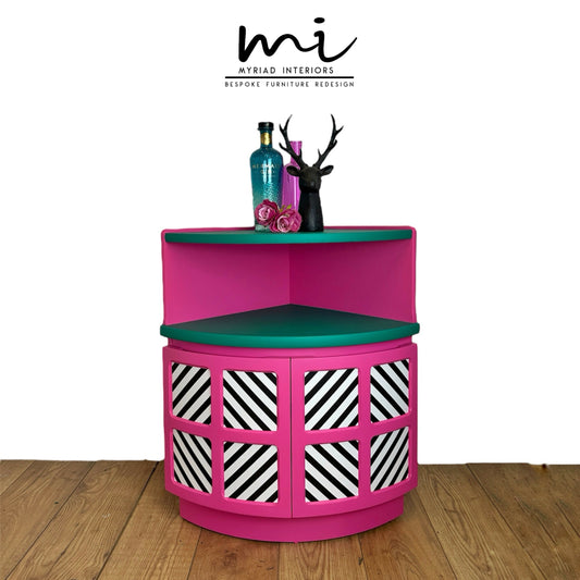 Maximalist hot pink and turquoise Nathan corner cabinet with black and white geometric design, mid century modern, bold, bright, statement