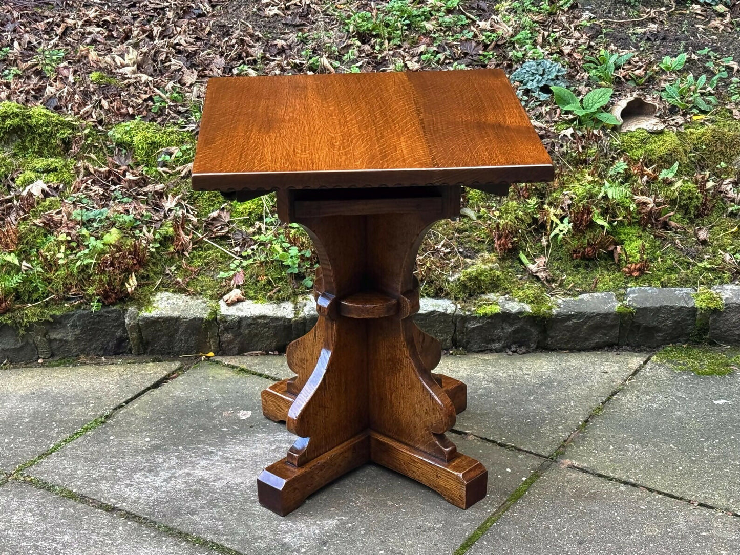 A RUPERT GRIFFITHS MONASTIC CARVED SOLID OAK LAMP TABLE / PLANT STAND
