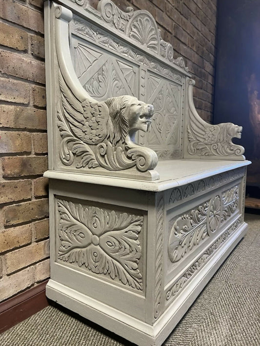 Edwardian antique Settle in solid oak with ornate carvings.