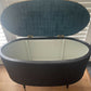 Black oval mid century modern ottoman - black paint William Morris style fabric
