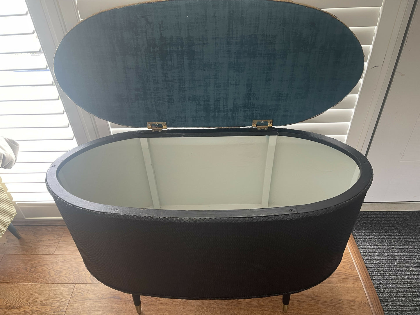 Black oval mid century modern ottoman - black paint William Morris style fabric