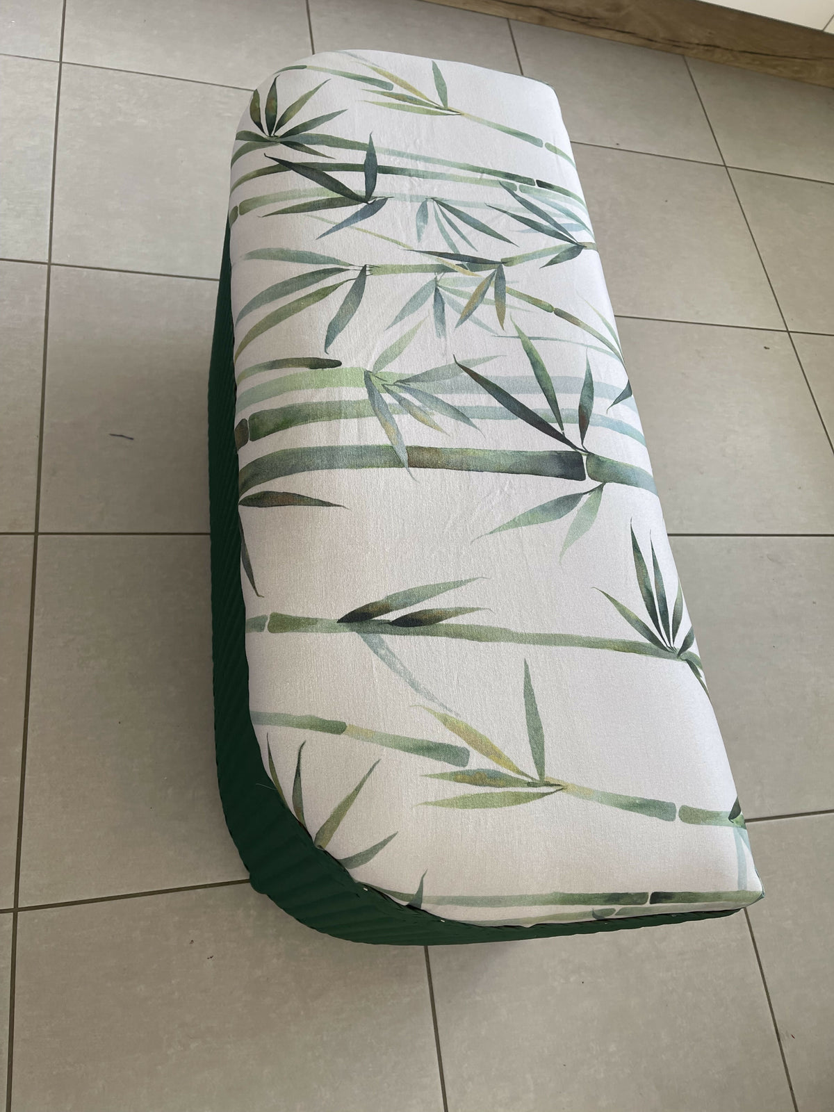 Lloyd loom ottoman. Matt Forest Green paint and matching bamboo motif fabric
