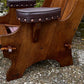 A NIGEL RUPERT GRIFFITHS MONASTIC CARVED OAK LEATHER FIRESIDE CHAIR / ARMCHAIR