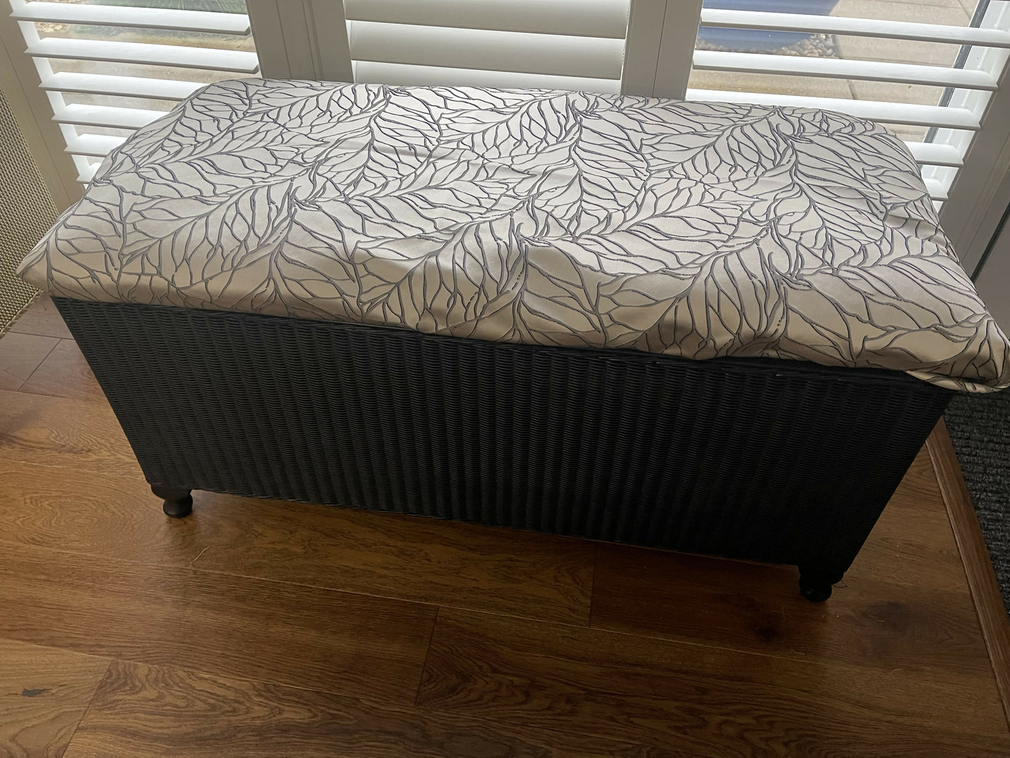 Black satin painted Lloyd loom ottoman. You choose the fabric