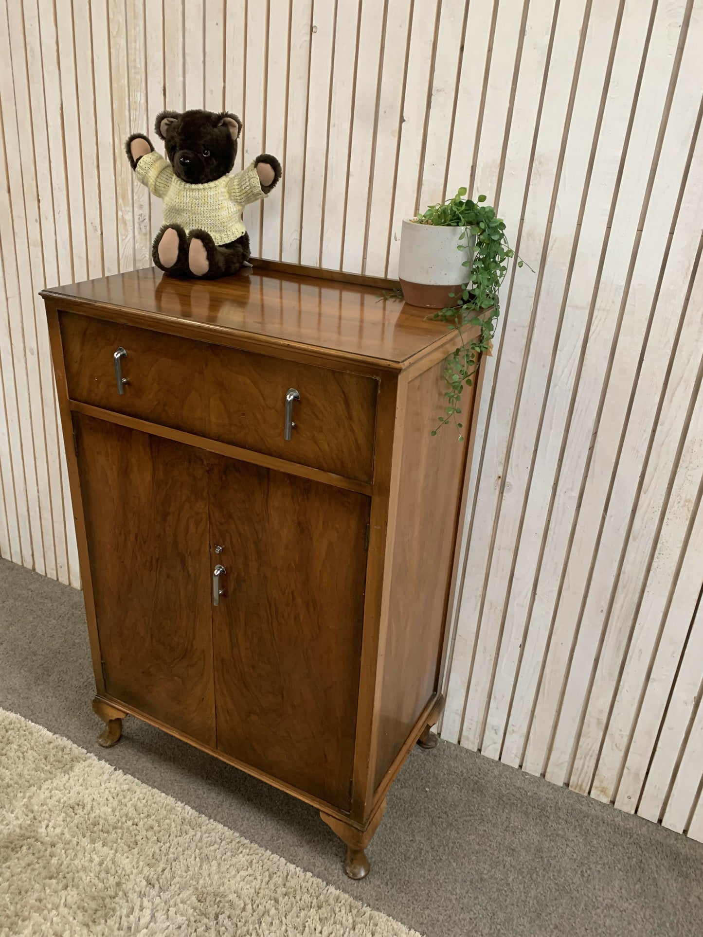 Vintage Art Deco burr walnut veneer cupboard featuring two doors and one drawer.