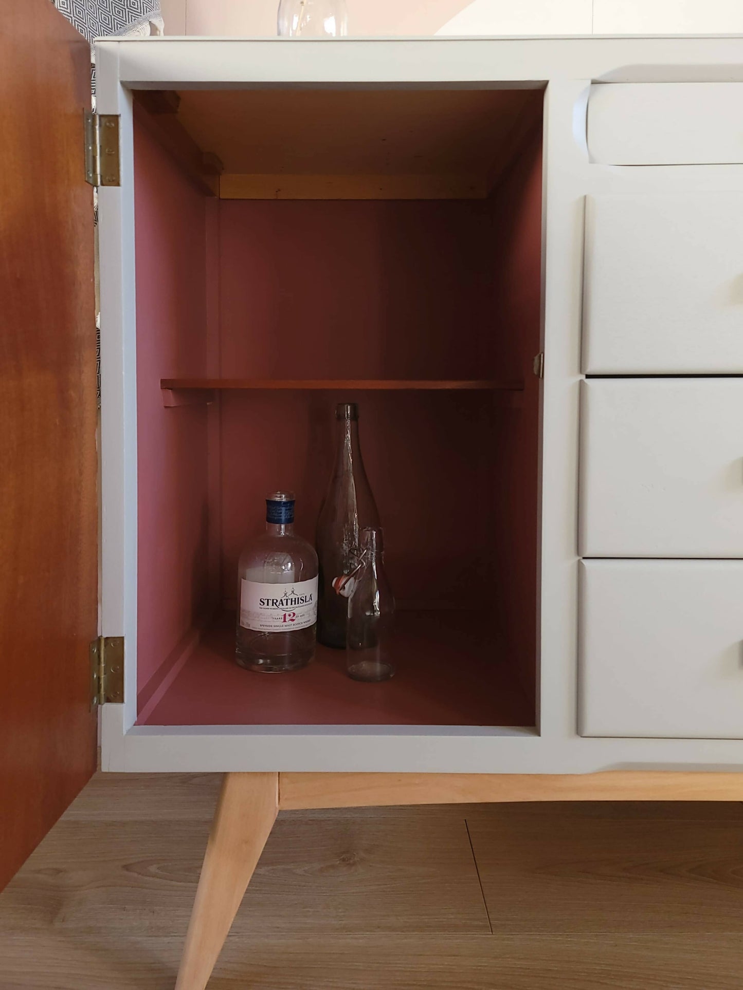 Shebert sideboard bottles in cupboard