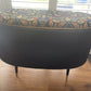 Black oval mid century modern ottoman - black paint William Morris style fabric